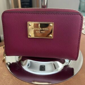 Michael Kors plum/rasberry wallet /wristlet has strap